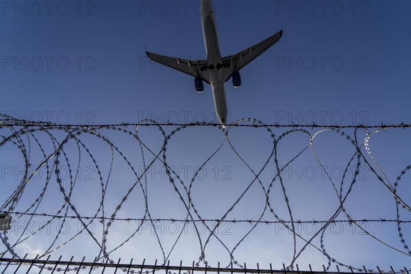 Symbolic image security at the airport, outer fence at Düsseldorf International Airport, steel wire