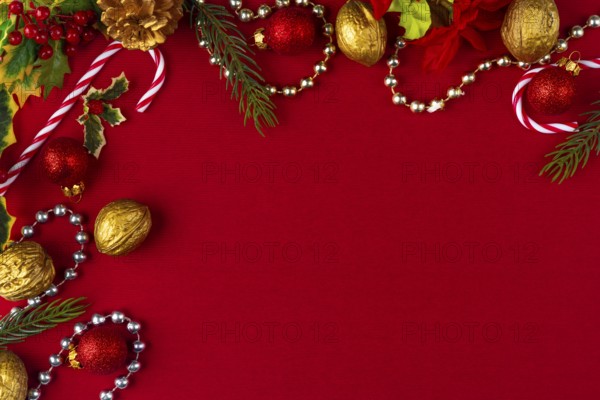 Christmas decoration frame with gold and red elements on a red background, copy room