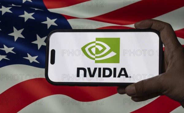 In this photo illustration, the Nvidia Corporation logo is displayed on an iPhone screen infront of