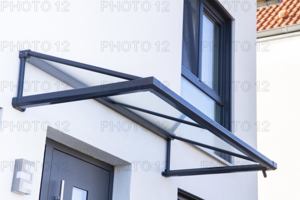 Aluminium and glass canopy at the entrance area of a residential building