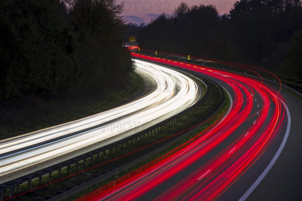 Light traces of cars on a motorway at night in a bend, Winnenden, Baden-Württemberg, Germany,