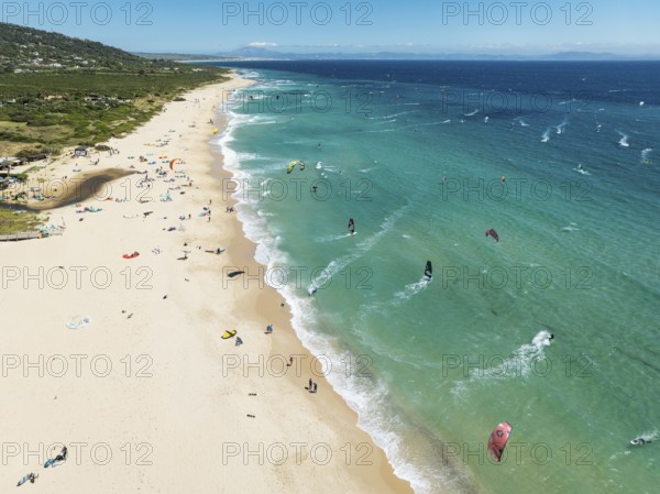Kite surfers at the Valdevaqueros beach near Tarifa. In the distance the coastline of Morocco.