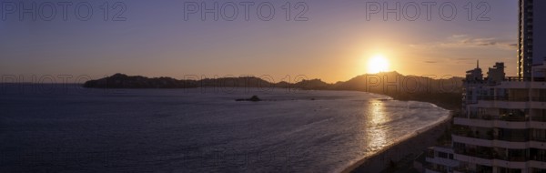 Mexico, Acapulco resort sunset beaches and scenic ocean views near Zona Dorada Golden Beach zone.,