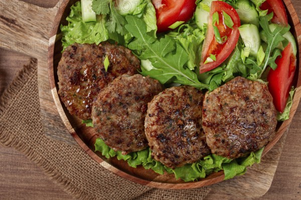 Fried cutlets, mixed minced meat, with vegetable salad, homemade, top view, no people