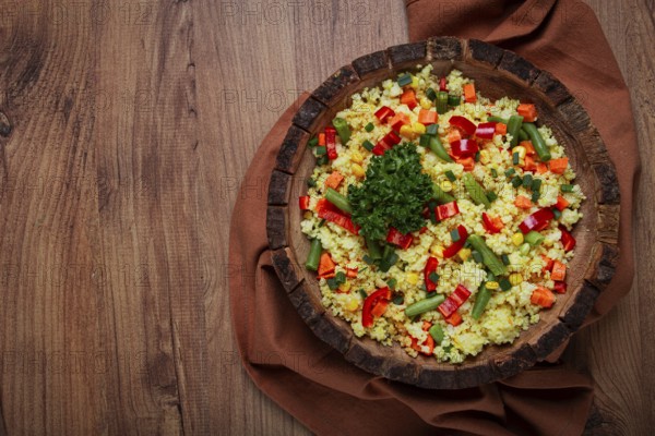 Couscous with vegetables, paprika, carrots, string beans, corn, homemade, top view, no people