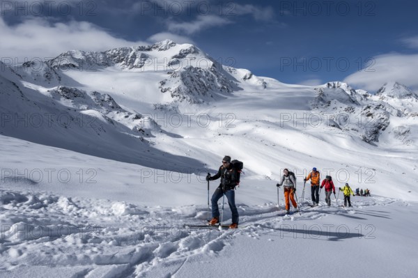Ski tourers, behind the summit of Monte Cevedale, snow-covered mountain landscape, Ortler Alps,