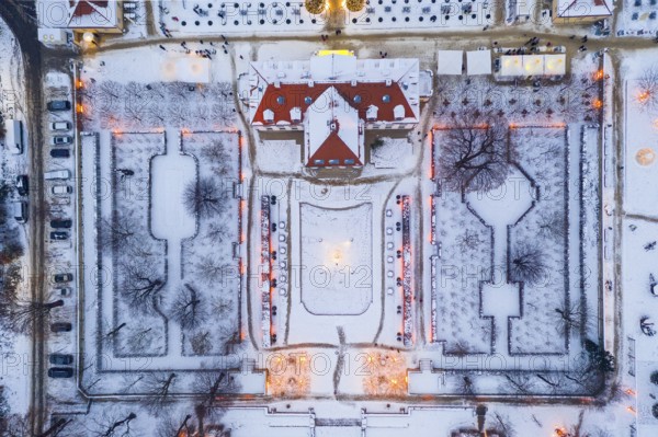 Aerial view of Wackerbarth Castle with castle park in snow and Christmas lights, Radebeul, Saxony,