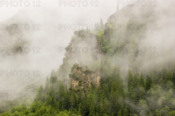 Wisps of mist cover the Karwendel mountains in the Großer Ahornboden nature reserve, Eng Valley,