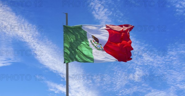 Los Cabos, Mexico, Mexican tricolor national striped flag proudly waving at mast in the air with