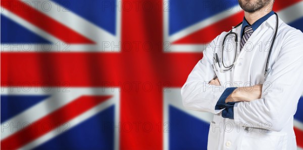 Doctor with crossed arms on British flag. UK Health and Care concept. Professional doctor on