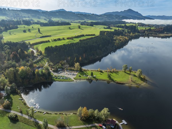 Sports facility and bathing area, lake Rottachsee, at village Petersthal, mt. Gruenten in the back,