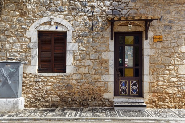 Façade with souvenir shop, typical stone house in Stoupa, former fishing village, Mani, Greece,