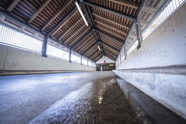 Perspective corridor with wooden beam ceiling and incidence of light, reflected on the floor, car
