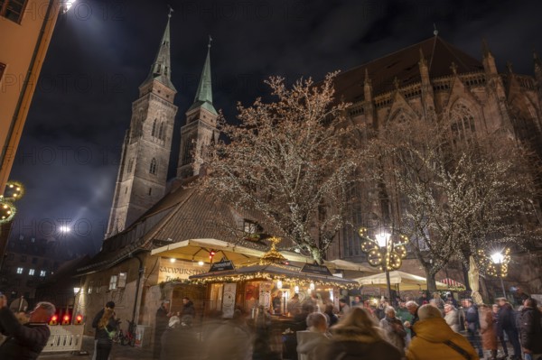 Christmas lighting at the Bratwursthäusle near St. Sebald, St. Sebald Church in the background,