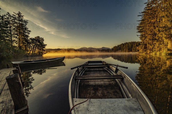 Boats in the autumnal Schmutter Weiher in the Allgäu near the municipalities of Halblech,