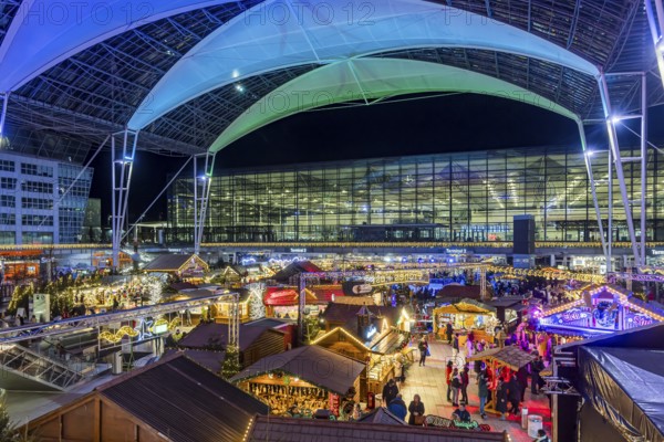 Christmas market at the airport in the evening, market stalls decorated for Christmas in front of
