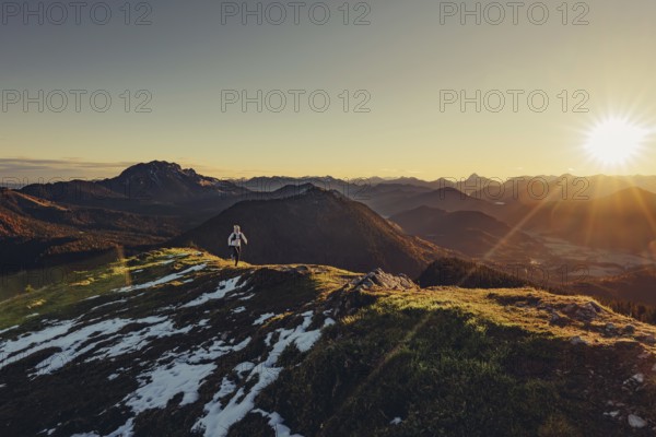 Trail running in autumn on the Jochberg on Lake Walchensee against the wonderful backdrop of the