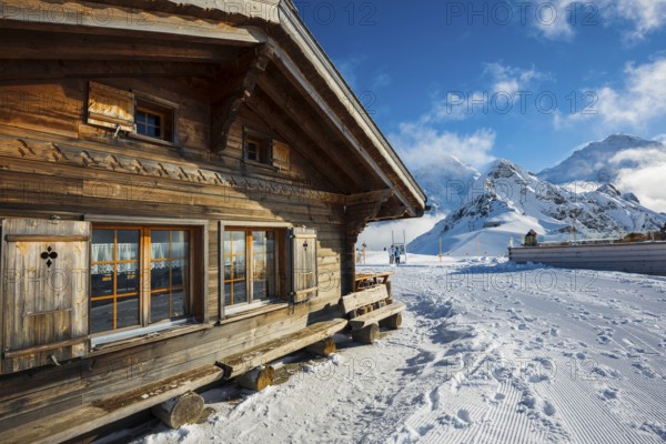 Wooden chalet and ski slope, with views of the Eiger, Mönch and Tschuggen, Grindelwald, Bernese