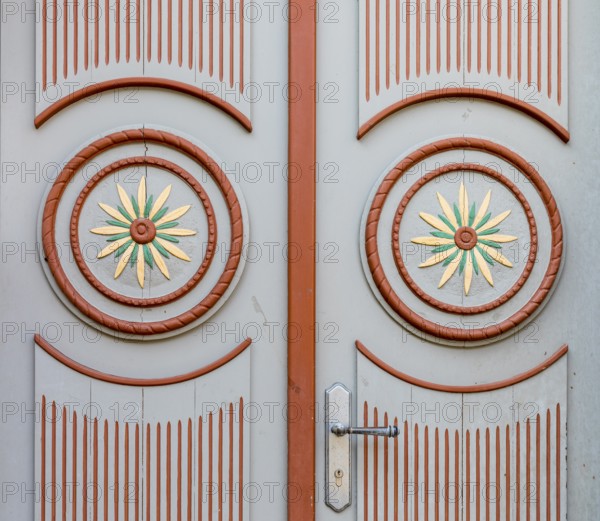Decorations on a front door with circles and flowers in red and white, Parchim,