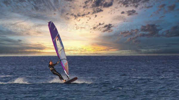 Sky exchanged, windsurfer enjoying the movement of the water at sunset, windsurfer, Meltemi
