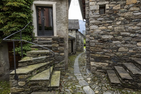 Typical Ticino stone houses in a narrow alley in the mountain village of Bordei, Centovalli, Canton
