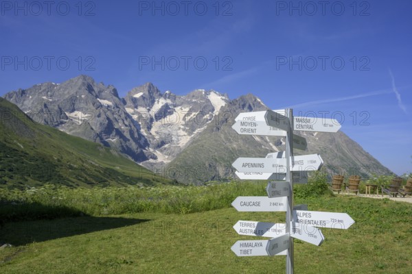 Signpost behind Pointe Piaget and La Meije seen from the botanical garden Jardin du Lautaret,