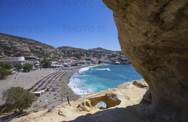 View from the rock caves to the beach of Matala, south coast, Crete, Greece, Europe