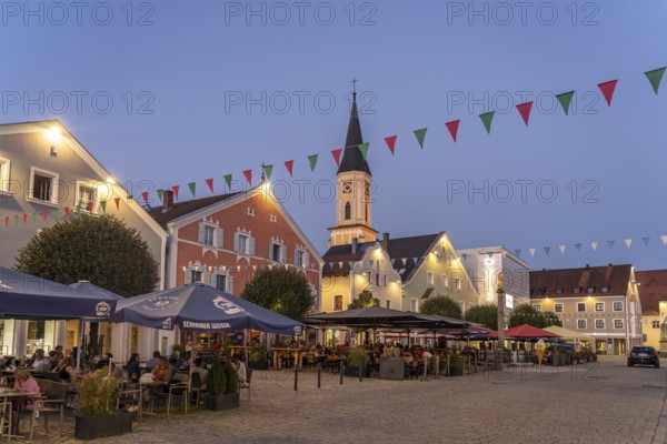 Ludwigsplatz with restaurants and the parish church of the Assumption of the Virgin Mary in the old