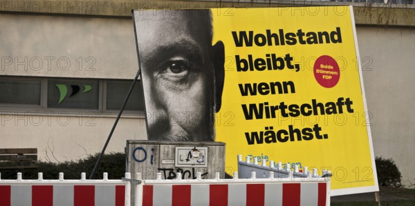 Large FDP election poster with Christian Lindner for the 2025 Bundestag election behind a barrier,