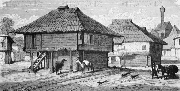Wooden houses in Bosnian town, a ladder to the dwelling, dogs, horses, packhorse, sandy road, town,