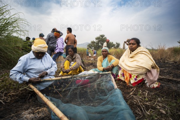 Villagers participate in a community fishing event on the occasion of the Bhogali Bihu festival at