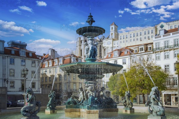 Lisbon, Rossio Square fountain and colorful historic buildings of historic city center