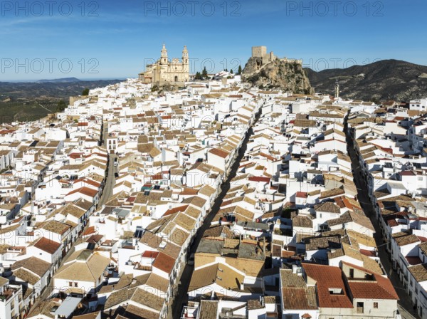 The hilltop White Town of Olvera with its La Encarnación church and Moorish castle. Aerial view.