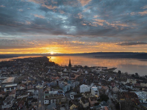 Aerial view of an atmospheric sunrise over the town of Radolfzell on Lake Constance with the