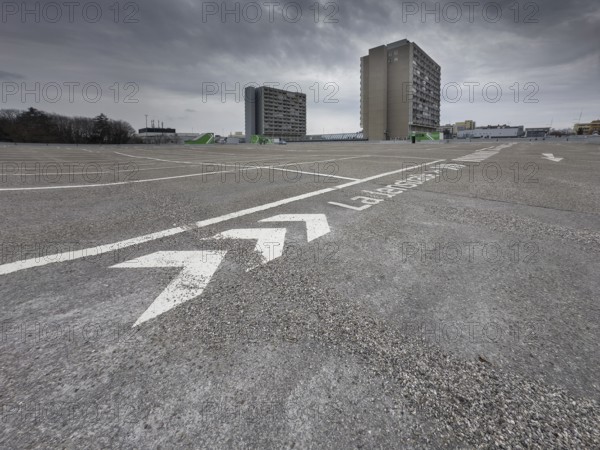 Symbolic image economic crisis, dark clouds in the sky, empty parking deck at