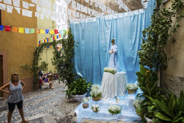 Decorated alley and celebrating people, feast of the Madonna of Regnos Altos, Bosa, district of