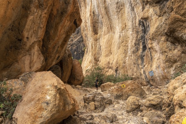 Tourist on the hiking trail through the gorge of Lissos near Sougia, Crete, Greece, Europe