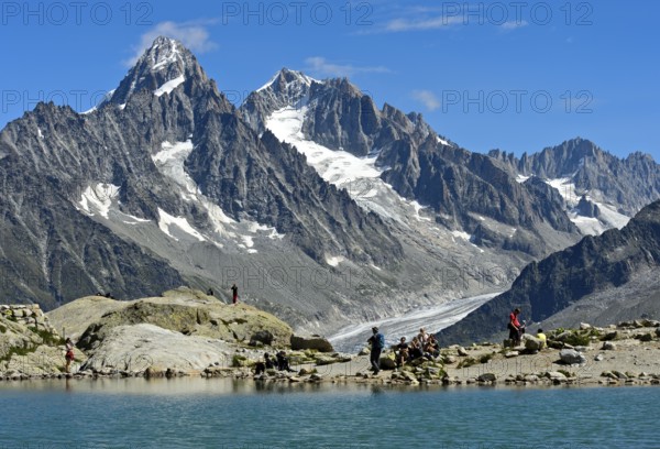 At the mountain lake Lac Blanc, behind it the peaks Aiguille du Chardonnet and Aiguille