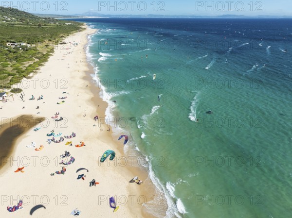 Kite surfers at the Valdevaqueros beach near Tarifa. In the distance the coastline of Morocco.