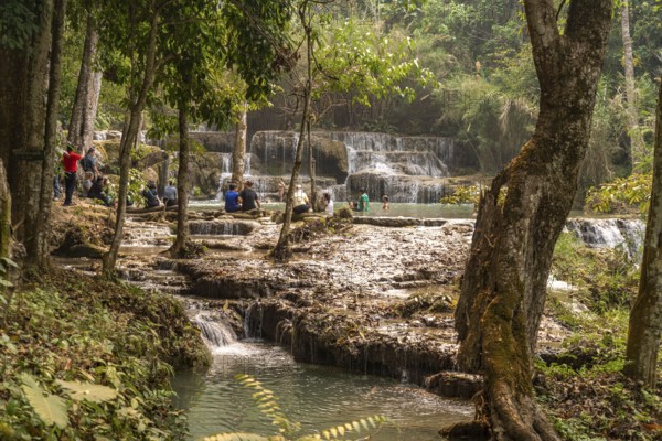 Tourists bathing in the Kuang Si waterfall near Luang Prabang, Laos, Asia