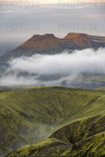 Fog between mountains, moss-covered volcanic mountain landscape, at sunset, Pakgil, Iceland, Europe