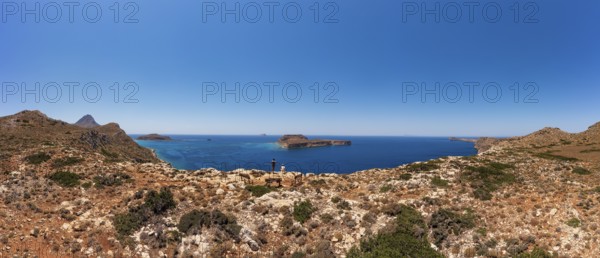 Hikers on the way to the cape of the Gramvousa peninsula with a view of the island of Imeri