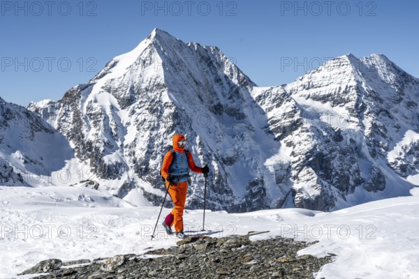 Ski tourers on foot, mountain panorama with snow-covered mountain landscape in winter, view of