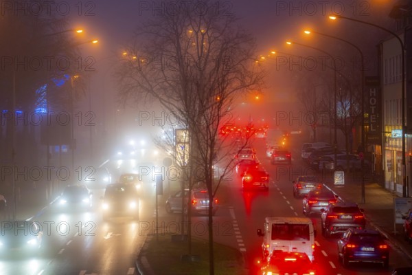 Dense fog, with visibility sometimes less than 100 metres, city centre traffic at rush hour on
