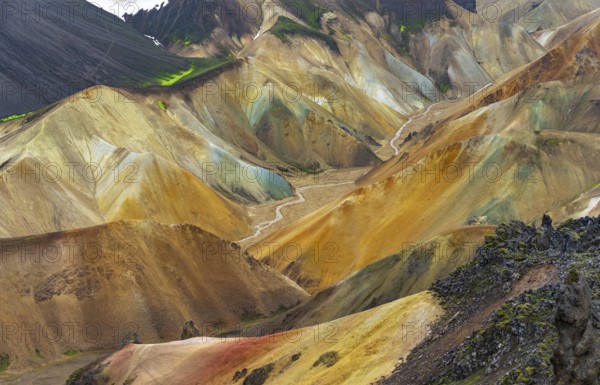 Small river between colourful rhyolite mountains, volcanic landscape, erosion landscape, view from