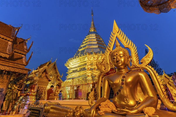 Buddha statue and Golden Chedi of the Buddhist temple complex Wat Phra That Doi Suthep, landmark of