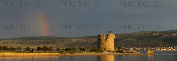 Old tower ruins on the coast with a rainbow in the distance at dusk, Vecka kula, Vecka Kula,