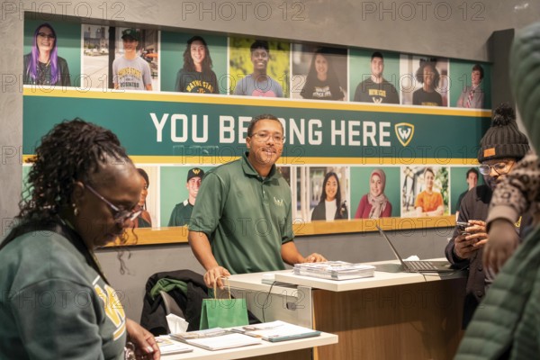Detroit, Michigan - At Wayne State University on Noel Night, a recruiter talks to potential
