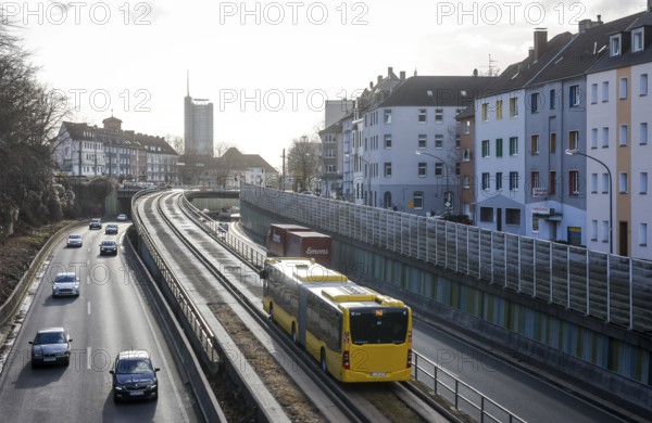 Essen, North Rhine-Westphalia, Germany - Cars and a public bus drive on the A40 motorway through