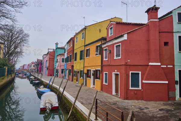 Colorful houses beside the waterway at 'Fondamenta di Terranova' with boats lying in the water on